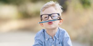 child balancing pencil on upper lip
