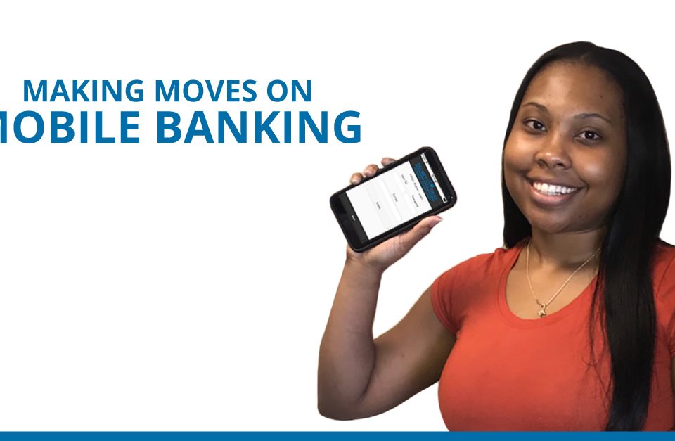 Making moves on mobile banking. Woman standing smiling with cell phone.