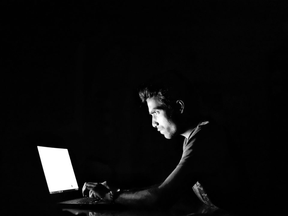 Man on laptop in the dark
