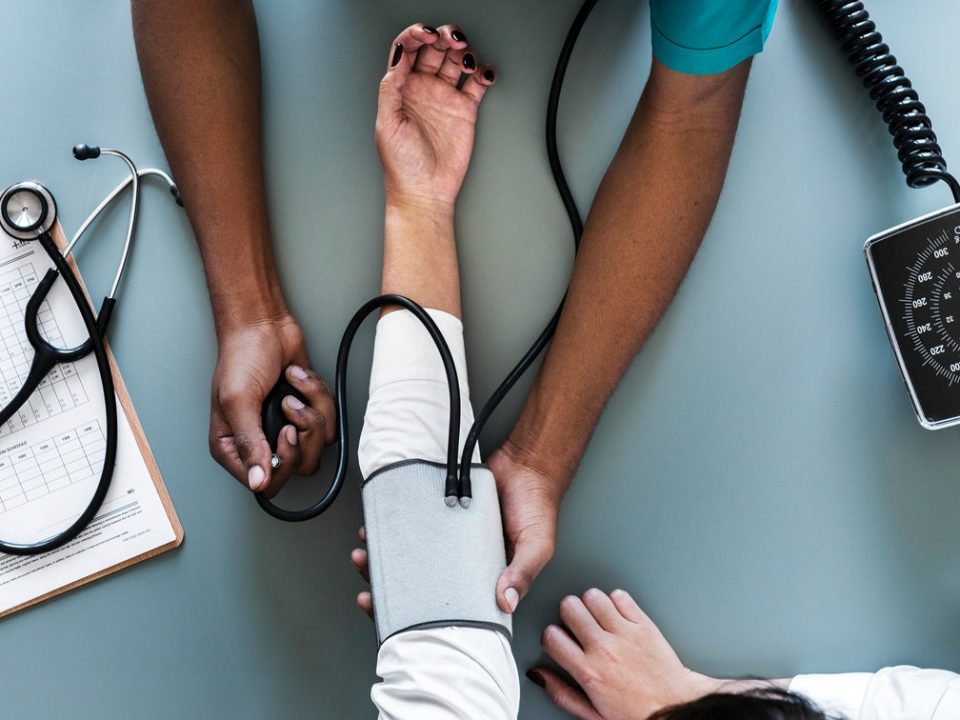 Doctor checking patient's blood pressure