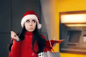 Sad girl spending all her money on holiday shopping