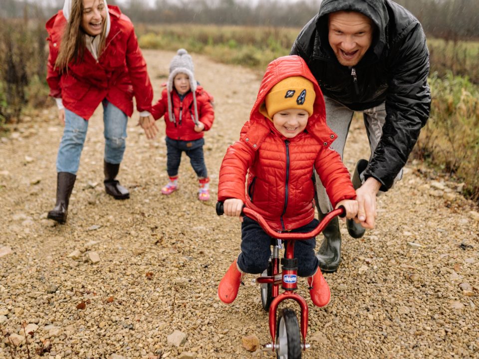 family with child riding a bike