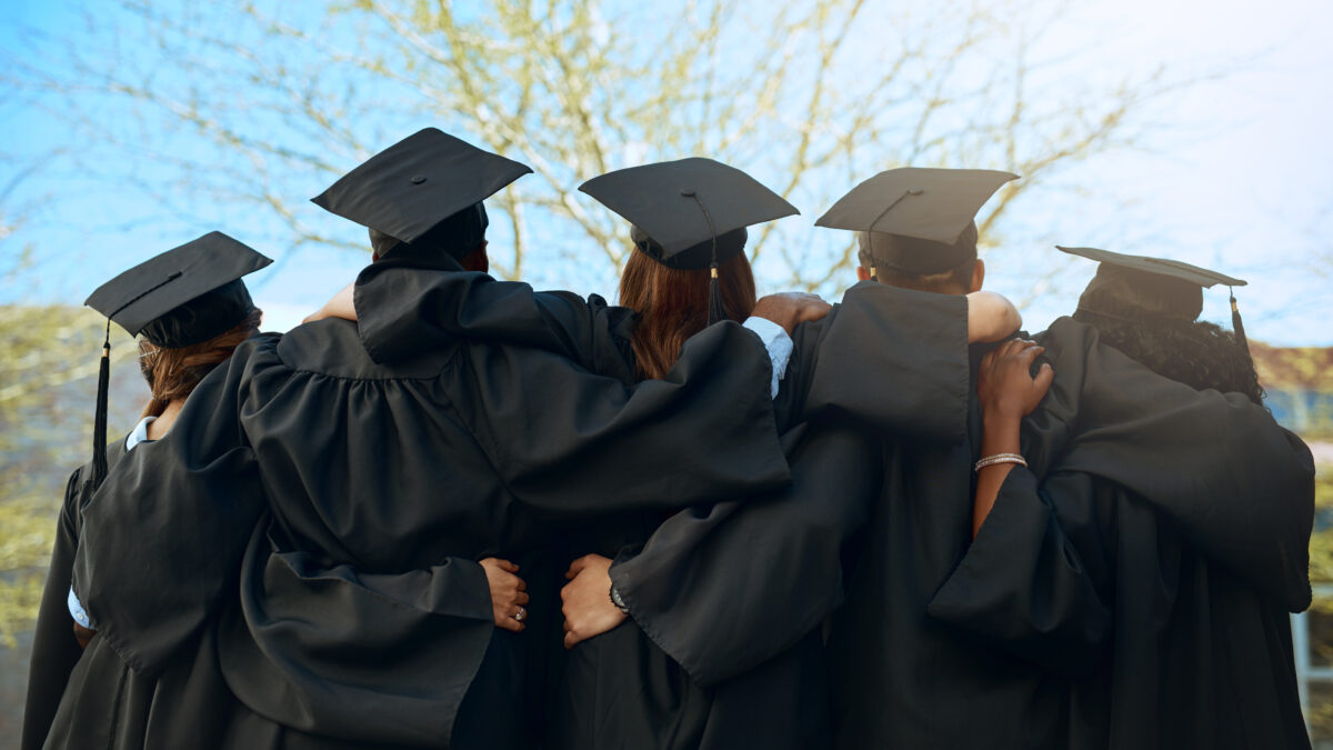 Embrace, group of graduates and together with joy on graduation day or celebrating academic achievement and outdoors. Certification, young students and hug outside or robes or hats and education.