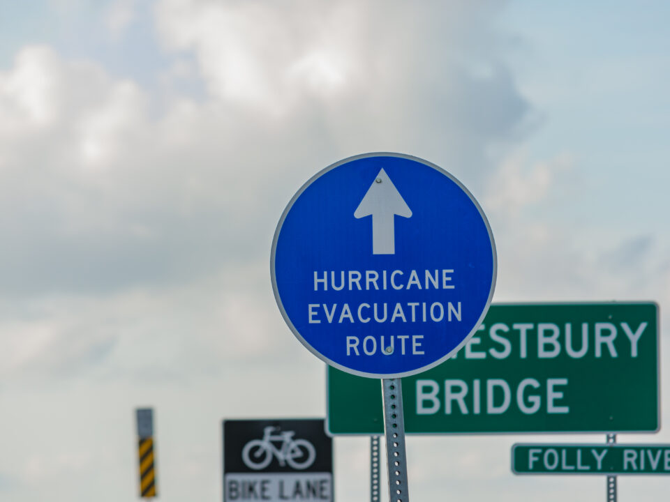 Blue sign with an arrow pointing up and text "HURRICANE EVACUATION ROUTE"